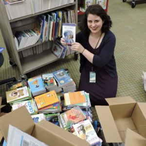 Ooh, staffer with stacks and stacks of books.