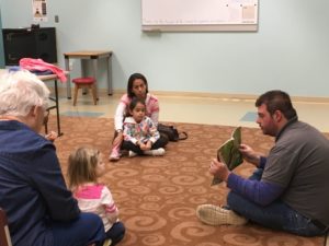 Listening to the Park Naturalist read the picture book - Raccoon on His Own by Jim Arnosky.