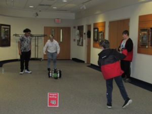 Teens Playing Penguin Bowling in the Art Gallery