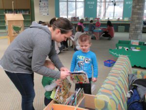 A family picking books in one of the Popular Characters neighborhoods.