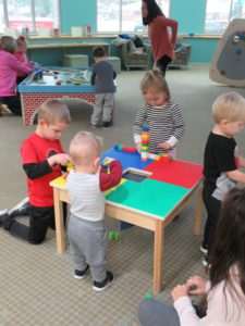 Kids playing with Duplos in the play area.