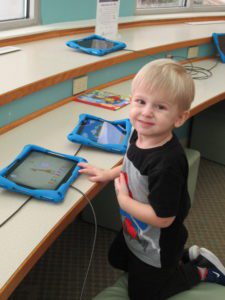 Happy kid at the tablets.