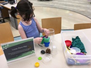 Child building at Loose Parts Play station