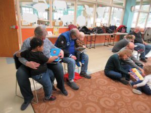 adults reading board books to kids during storytime