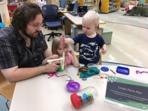 man and two kids play creatively with random household things