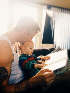 Man reads to baby